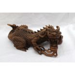 A Chinese hardwood carving of a dragon 36cm long