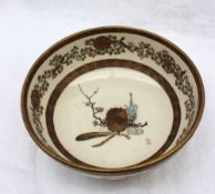A Japanese Satsuma pottery bowl, decorated with phoenix, flowers and leaves,