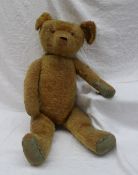 A mohair teddy bear,  with a pronounced snout, hump back and moveable limbs,