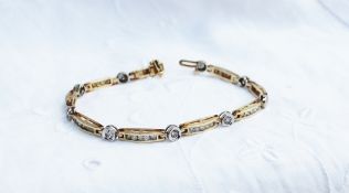 A tennis bracelet set with round brilliant cut diamonds to a yellow metal setting marked 14k,