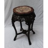 A Chinese hardwood and marble inlaid jardiniere stand with shaped beaded top above a floral and