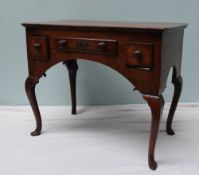 An 18th century oak lowboy the rectangular planked top above three drawers on cabriole legs and