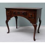 An 18th century oak lowboy the rectangular planked top above three drawers on cabriole legs and