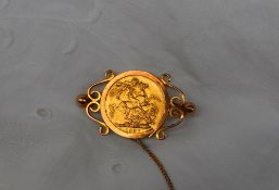 A Victorian gold sovereign dated 1887 in a 9ct yellow gold slip mount brooch,