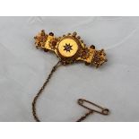 A 15ct yellow gold brooch, with a central diamond and wirework and ball decoration,