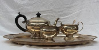A George V silver three piece teaset, with a beaded rim,