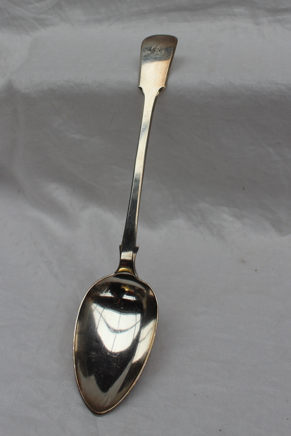 A George IV silver fiddle pattern serving spoon, London, 1824, possibly William Johnson,
