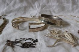 Two silver slave bracelets together with a silver fringe necklace,