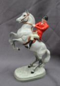 A Beswick model of a huntsman on a rearing dapple grey horse, Model No.