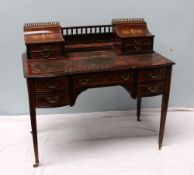 An Edwardian rosewood Carlton house desk, the superstructure with a spindle gallery,