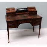 An Edwardian rosewood Carlton house desk, the superstructure with a spindle gallery,