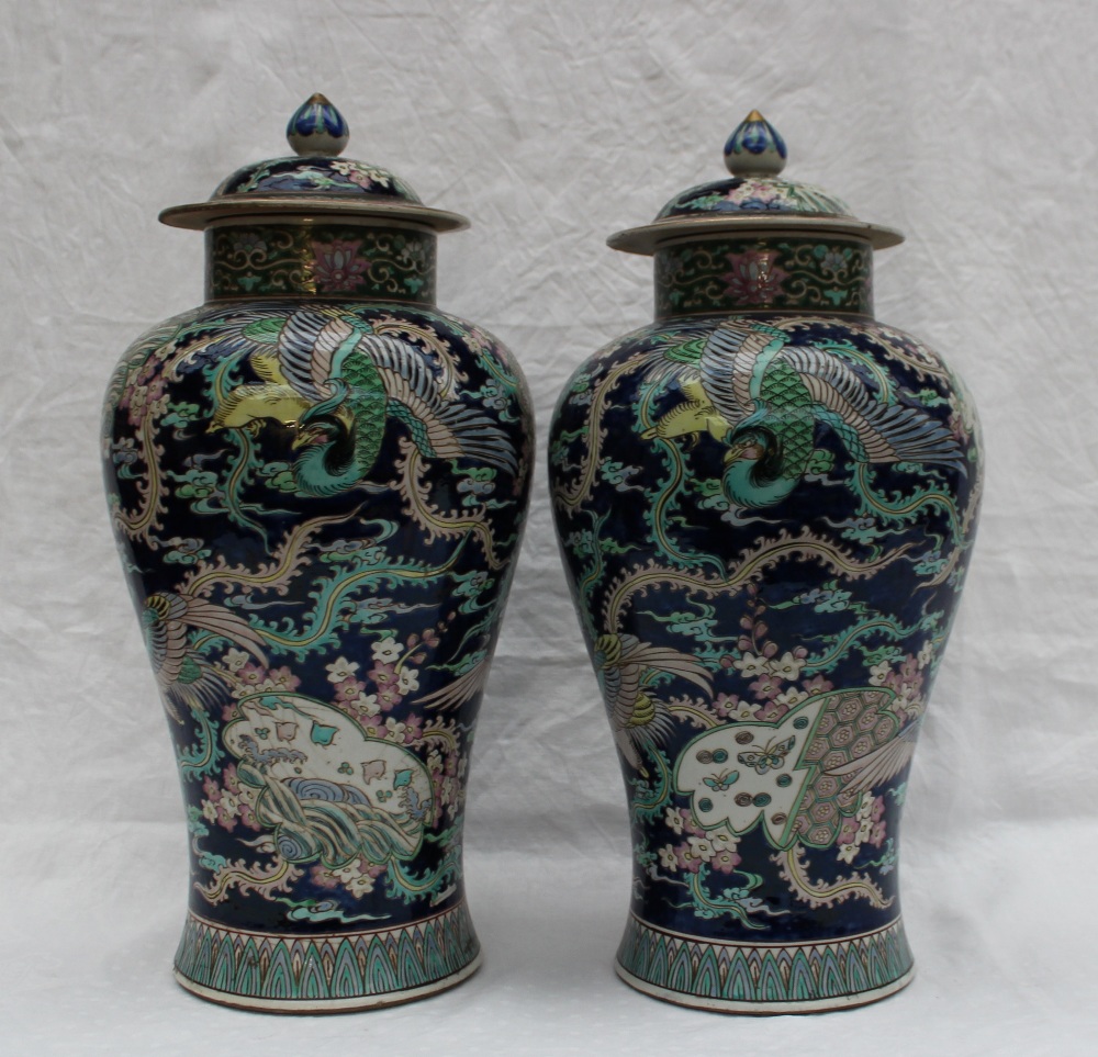 A pair of Chinese porcelain baluster vases and covers with polychrome decoration of butterflies and - Image 2 of 6