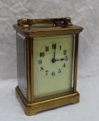 A cased carriage timepiece, the case with a moulded top and bracket feet,