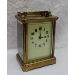 A cased carriage timepiece, the case with a moulded top and bracket feet,