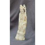 A 19th century Japanese ivory figure group depicting a a man and child holding a staff on a shaped