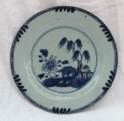 A Chinese porcelain plate decorated with a landscape scene,