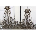 An impressive pair of gilt metal and glass mounted sixteen branch chandeliers with glass lustre