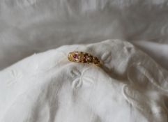 A ruby and seed pearl gypsy ring to an 18ct gold shank,