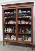 A late 19th / early 20th century mahogany bookcase with a moulded cornice above a pair of glazed
