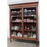 A late 19th / early 20th century mahogany bookcase with a moulded cornice above a pair of glazed