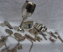 An Elizabeth II silver goblet, Birmingham, 1971 together with silver napkin rings, silver ingots,
