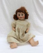 A Porzellanfabrik Burggrub Porcelain Headed Doll numbered 169/6 having open mouth and closable eyes,