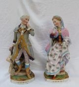 A pair of continental porcelain figures depicting a lady and gentleman descending steps,