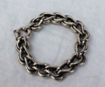 A chunky white metal bracelet with interlocking links,