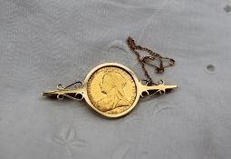 A Victorian gold sovereign dated 1899, mounted in a 9ct gold brooch,