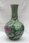 A large Chinese celadon vase with raised floral decoration in pinks, blues and greens,