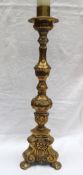 A large brass candlestick, cast with flowerheads and leaves,