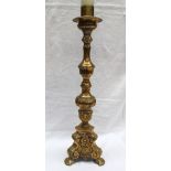 A large brass candlestick, cast with flowerheads and leaves,