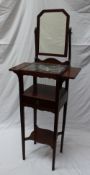 A 19th century mahogany washstand the back with a rectangular mirror above a marble top and shelves