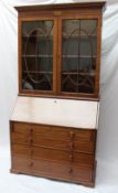 A 19th century  mahogany bureau bookcase the moulded dentil cornice above a shell inlaid frieze