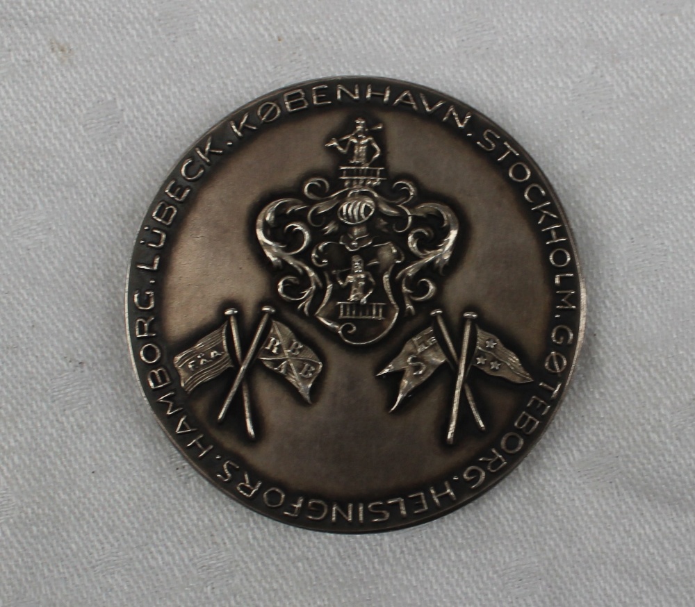 A white metal medallion cast with a portrait and inscribed Franck & Tobiesen 1-4-1940, - Image 2 of 2