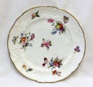 A Nantgarw porcelain plate, decorated with sprigs of garden flowers,