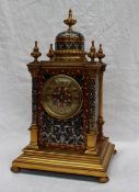 A 19th century gilt metal and champleve enamel decorated mantle clock, with a vase finial and dome ,