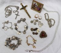 Assorted costume jewellery including a yellow metal charm bracelet, a bracelet set with coins,