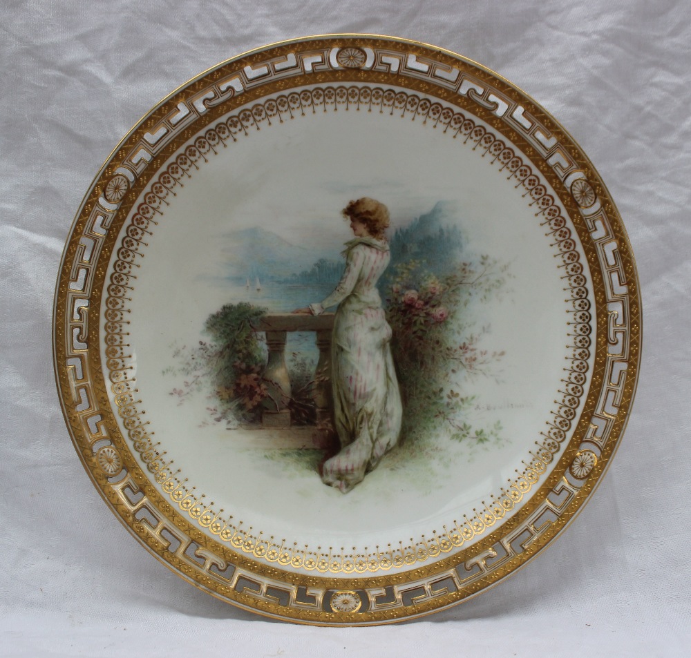 A Minton porcelain cabinet plate painted with a lady on a terrace overlooking a lake with hills in