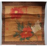 An Oriental study of Chrysanthemums on silk, with a decorative embroidered border,