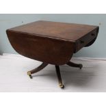 A Regency mahogany sofa table the rectangular top with drop flaps above drawers to either end on  a