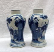 A pair of Chinese porcelain baluster vases painted with figures in a garden,