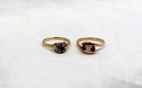 An 18ct yellow gold ring, set with a central diamond and two rubies,