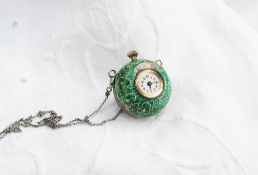 A silver and green enamel decorated pendant ball watch,