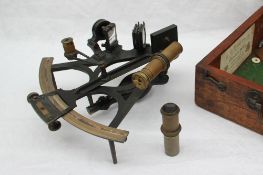 A black lacquer sextant with a brass and silvered vernier, mirror,