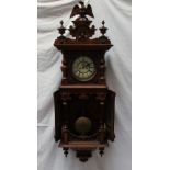 A walnut Vienna regulator type wall clock with an eagle surmount, half section columns,