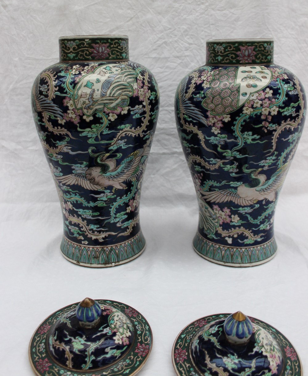 A pair of Chinese porcelain baluster vases and covers with polychrome decoration of butterflies and - Image 4 of 6