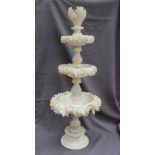 A 19th century alabaster table centrepiece with three tapering dishes carved with leaves on a