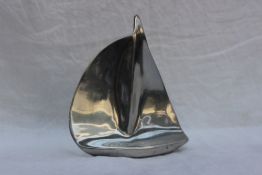 A Hoselton white metal sculpture of a goose in flight, signed, No.