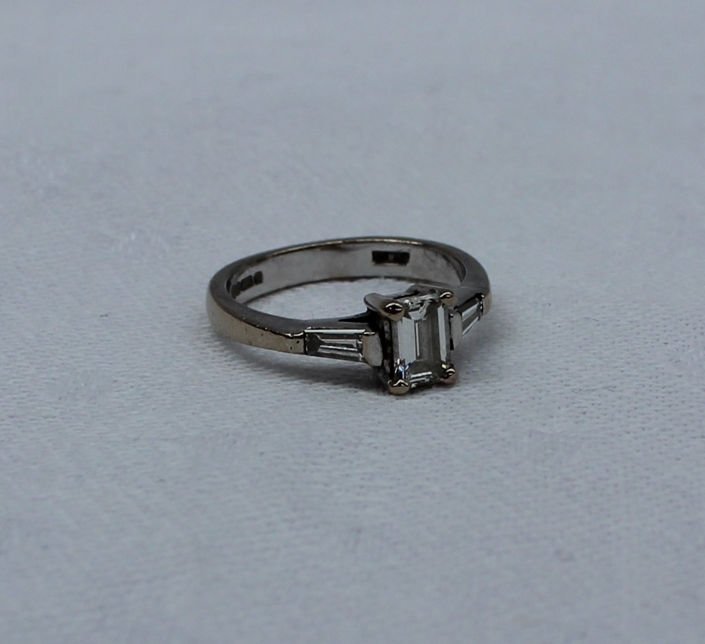 A solitaire diamond ring, the emerald cut diamond measuring 5mm x 4mm x 2mm, - Image 4 of 7